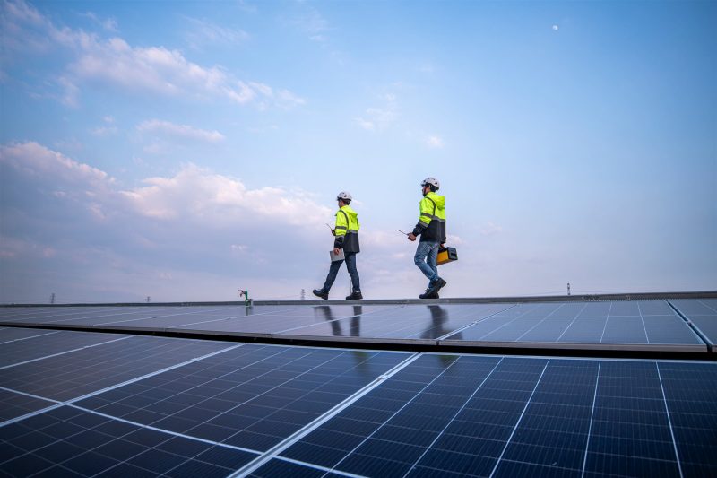 Solar panel installers on a rooftop